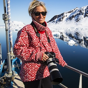 A photographer on a sailboat in Svalbard